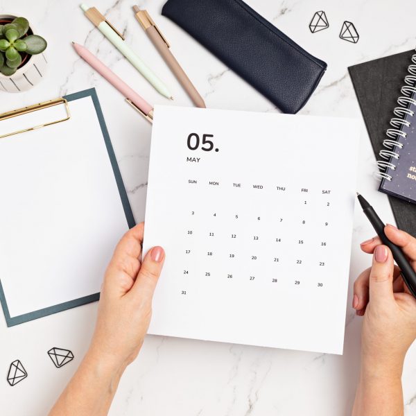 Desktop with calendar for may and office supplies Desktop with calendar for may and office supplies. home office, social media blog, schedule, planning concept. Flatlay, top view